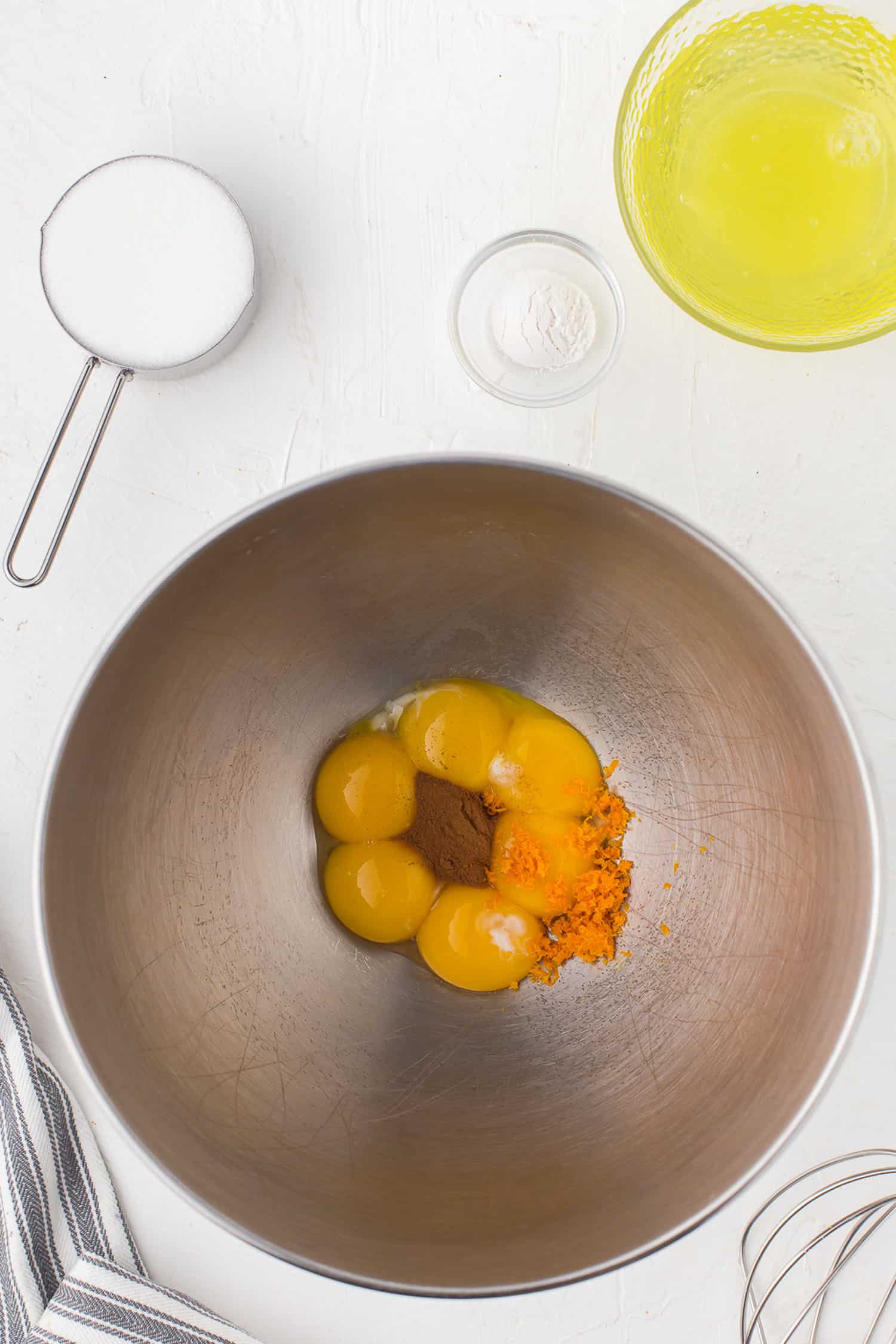 egg yolks, cinnamon, and orange zest in bowl