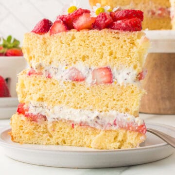 slice of italian strawberry cake on white dish with fork