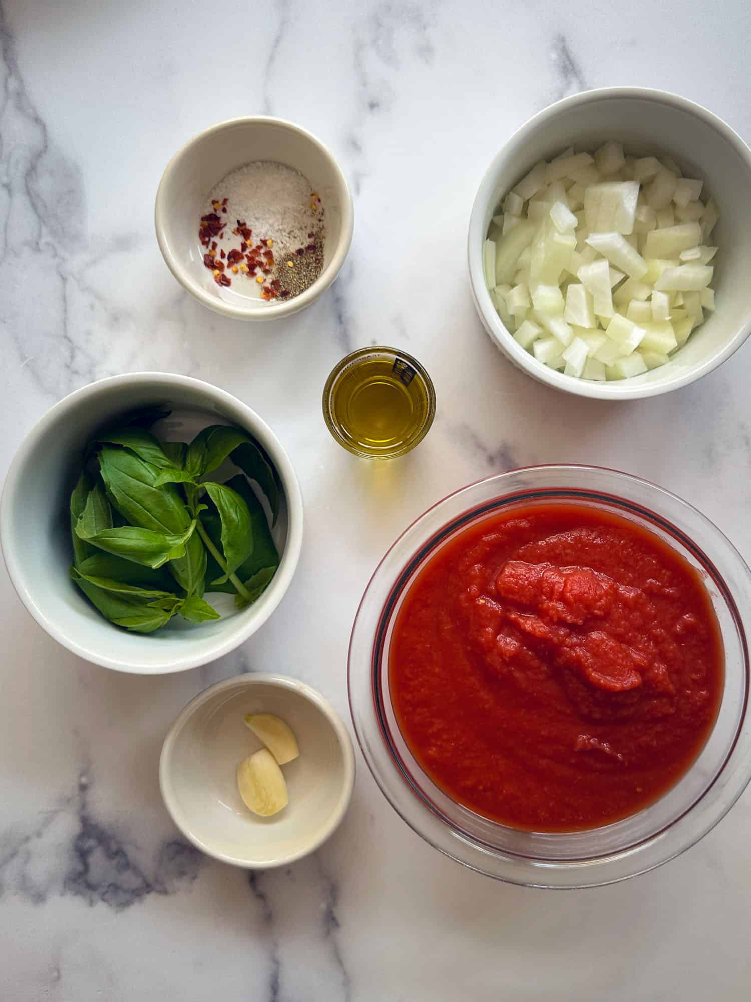 ingredients for marinara sauce on marble table