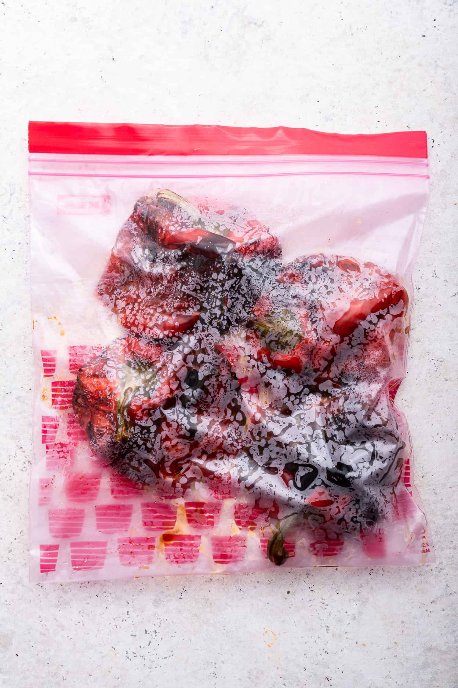 charred peppers in sealed plastic bag, steaming