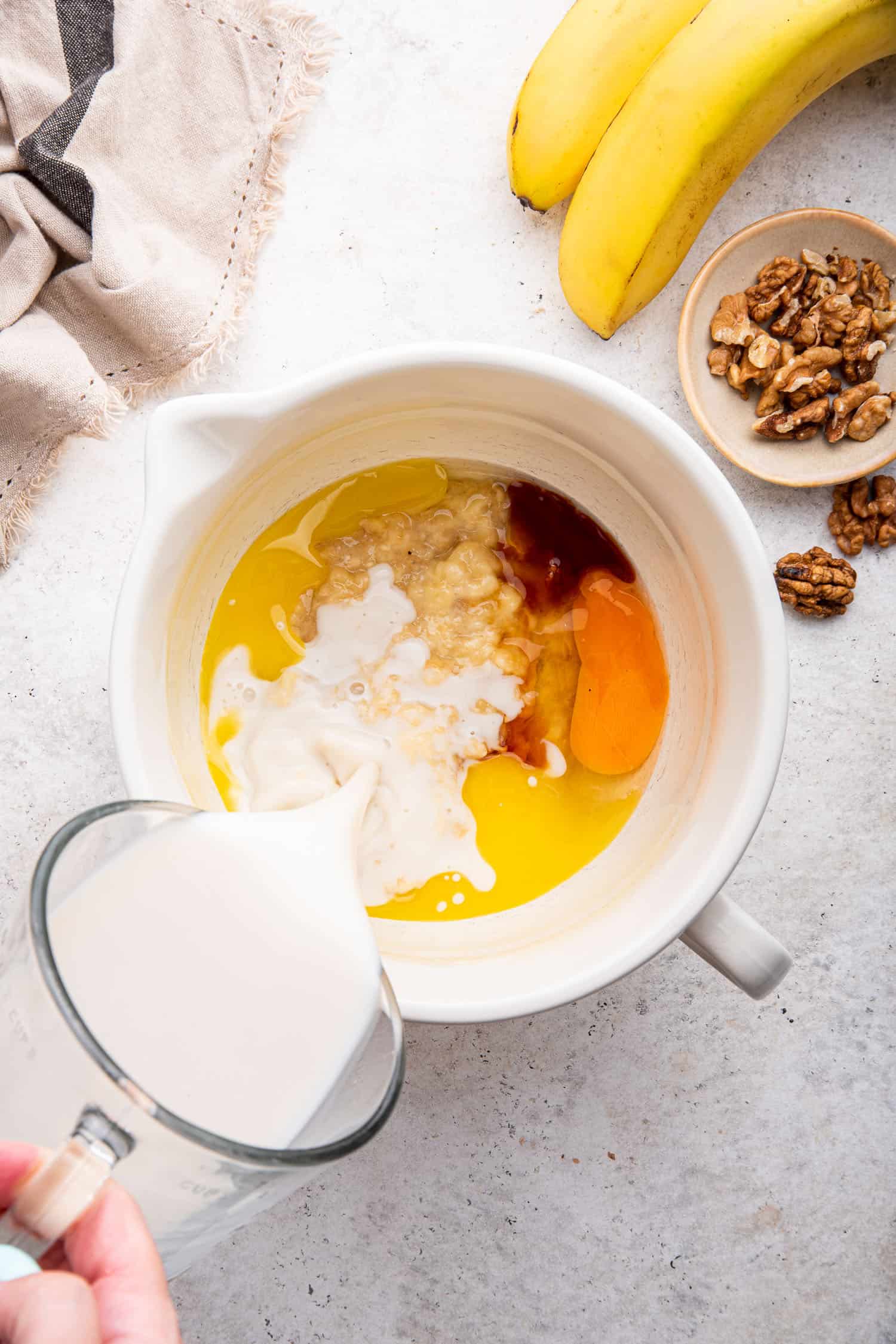 wet ingredients for baked oats in large mixing cup