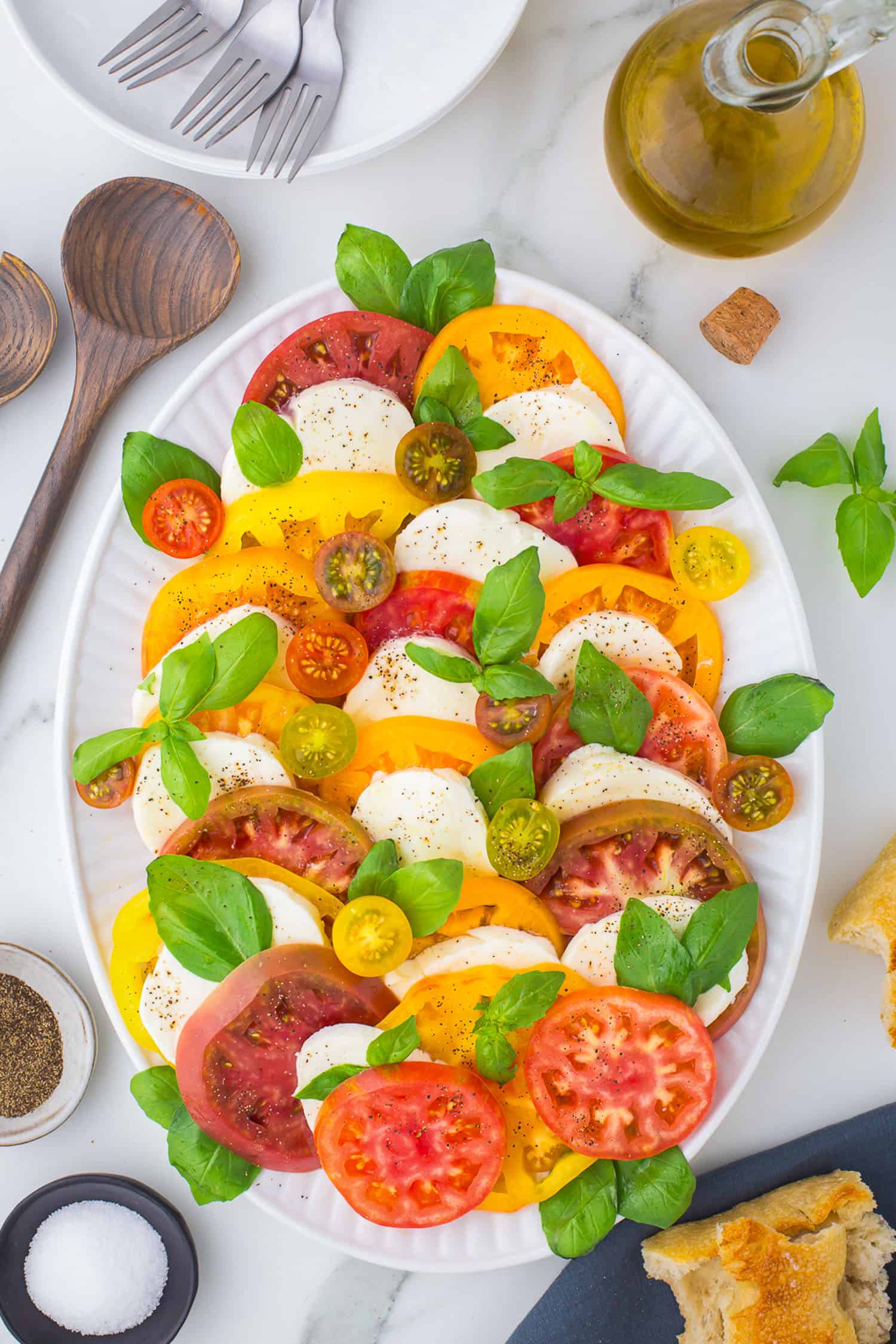 top view of caprese salad on white platter