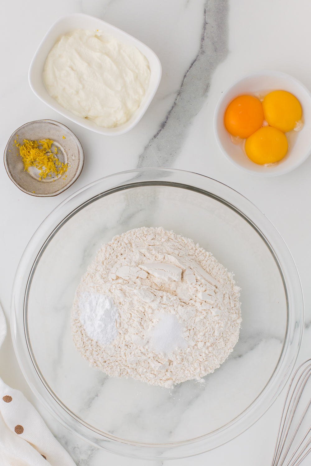 mixing dry ingredients for pancakes in glass bowl