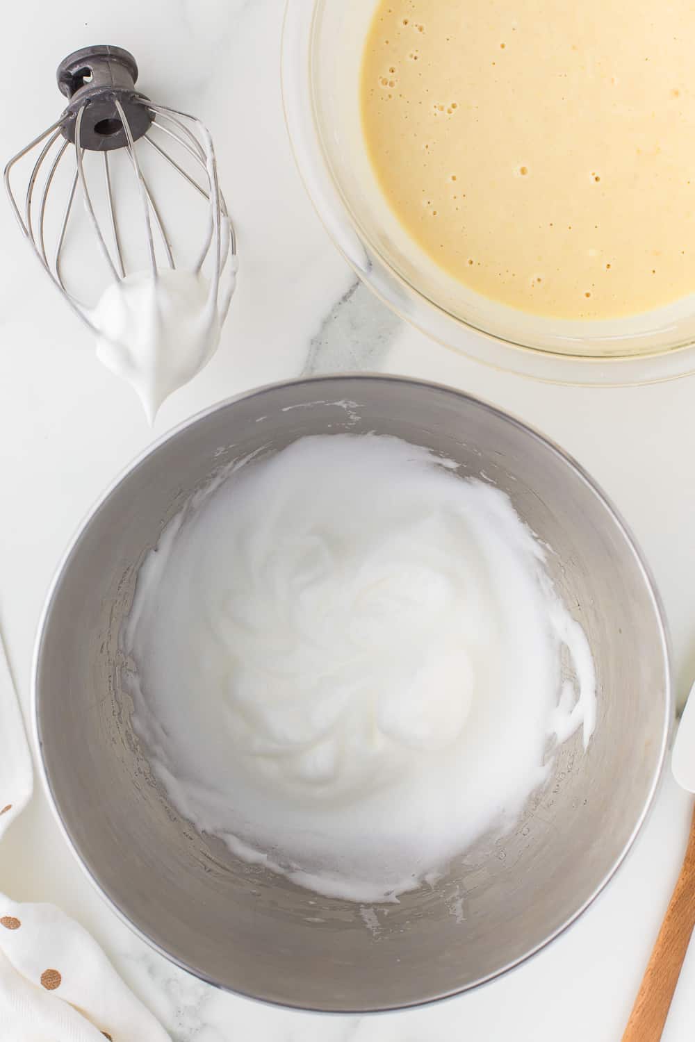 whipped egg whites in stainless steel bowl