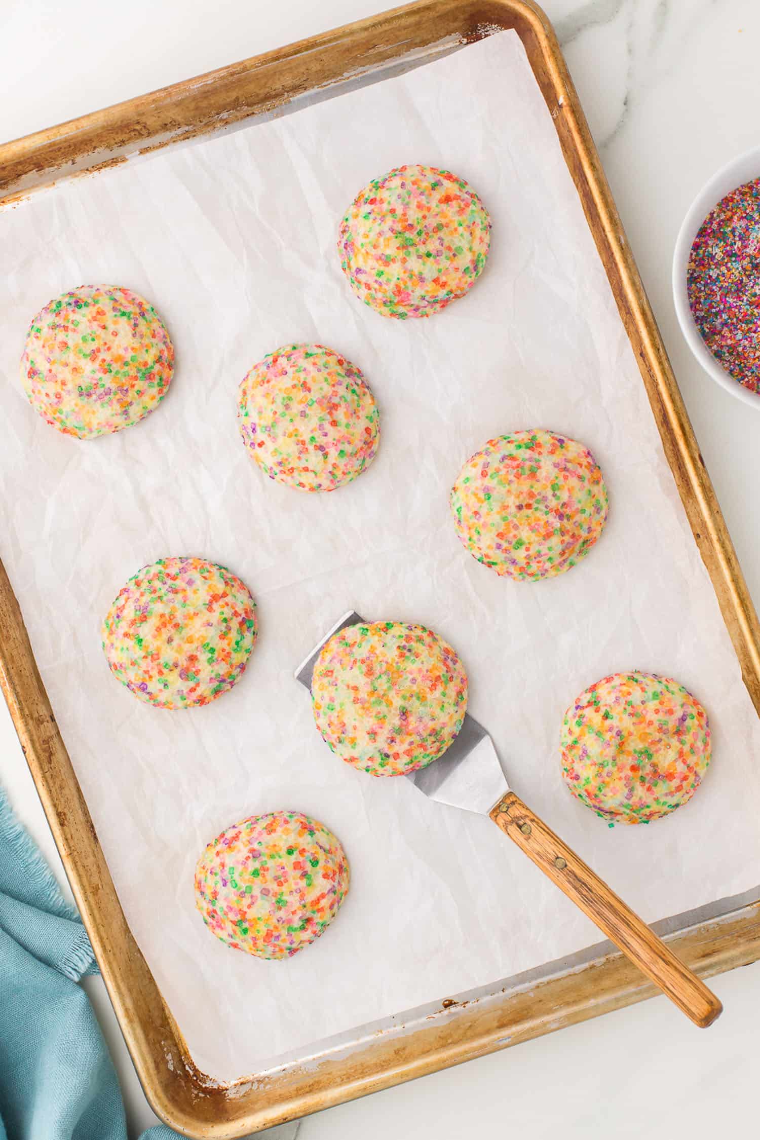 just baked cookies on tray with spatula