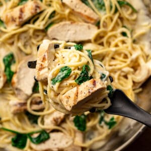 forkful of chicken florentine pasta from pan