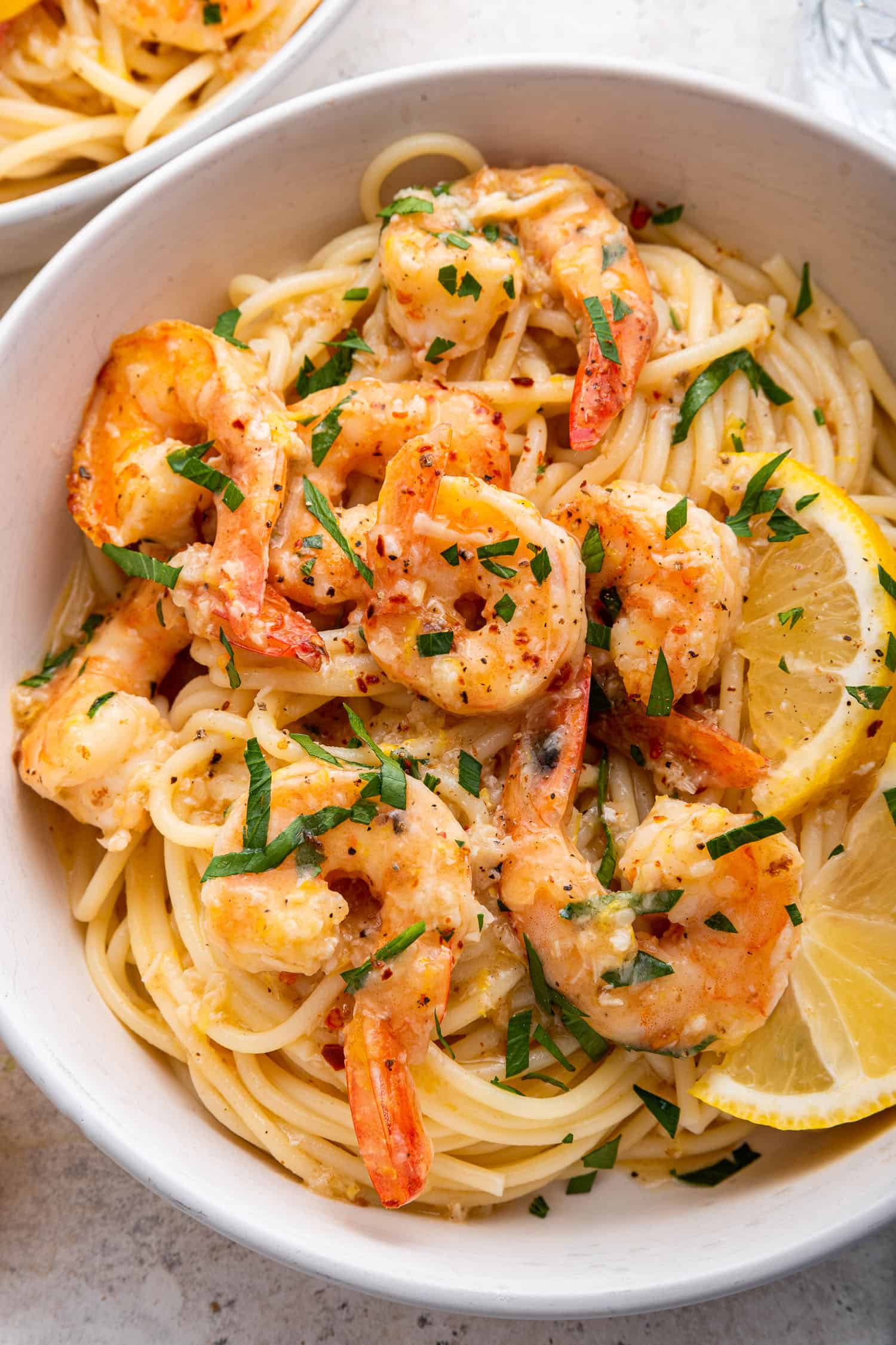 close up view of lemon garlic shrimp pasta with parsley