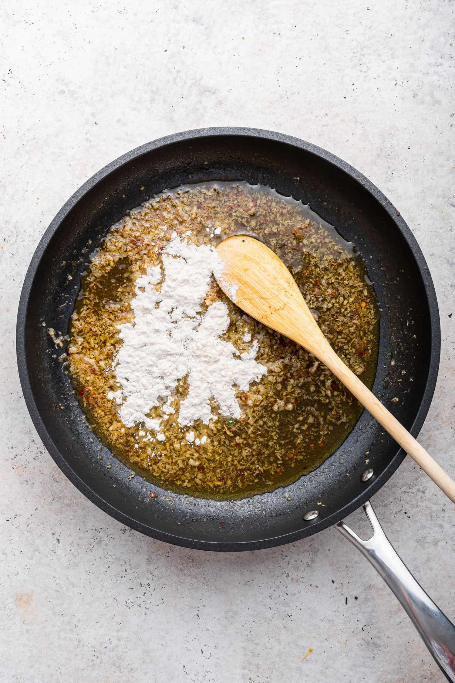 mixing flour into pan with oil to make roux