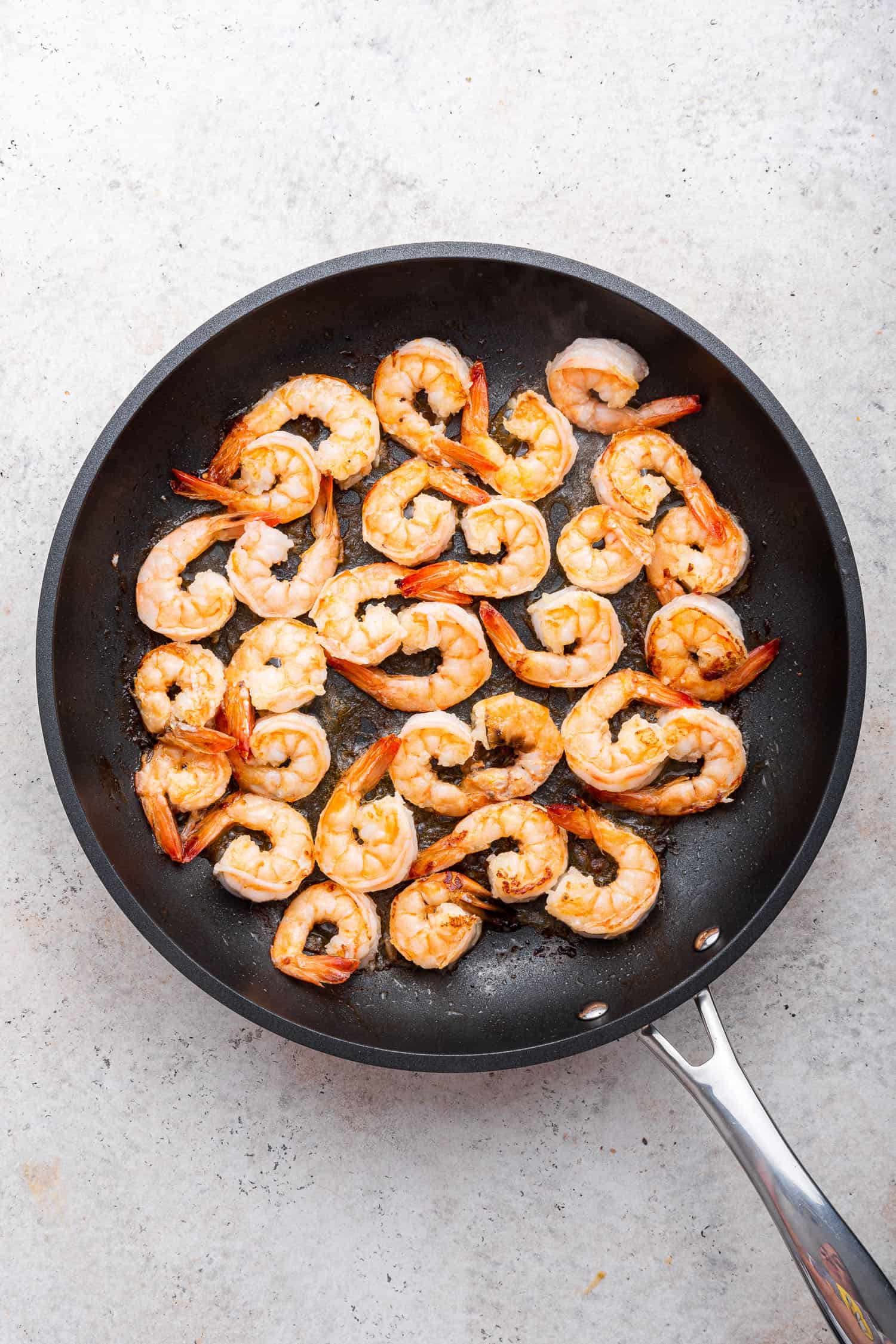 cooked shrimp in black pan