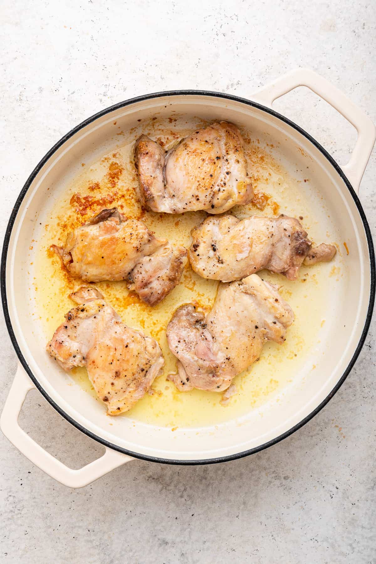 Sauteed chicken thighs in large pot.