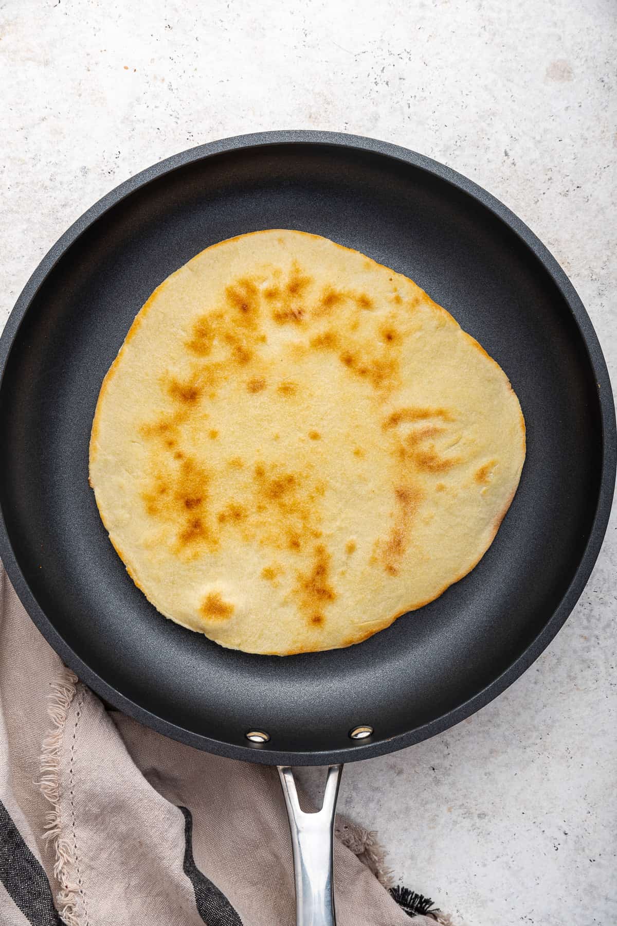 Piadina cooking in skillet. 