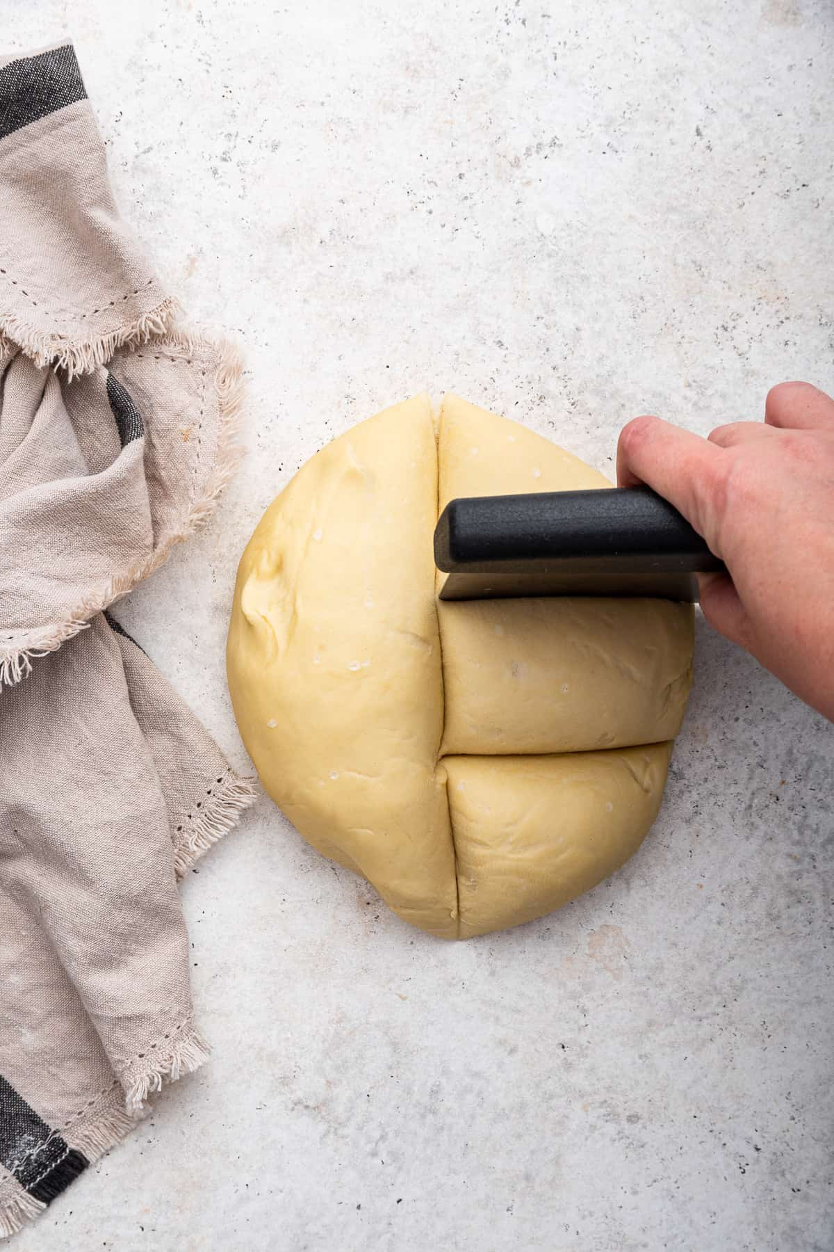 Cutting piadina dough into 6 pieces.