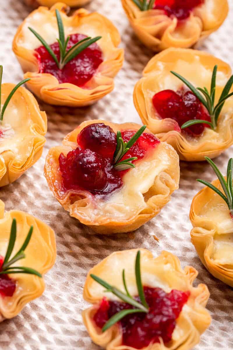 Close up view of cranberry brie bites with rosemary.