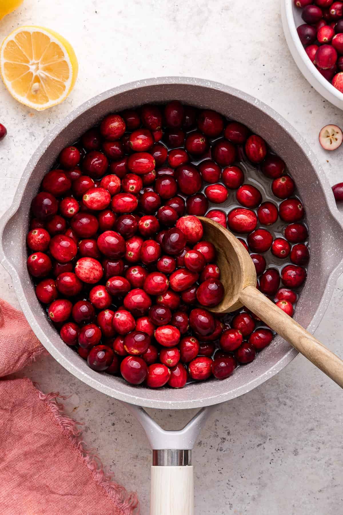 Adding cranberries to simple syrup.