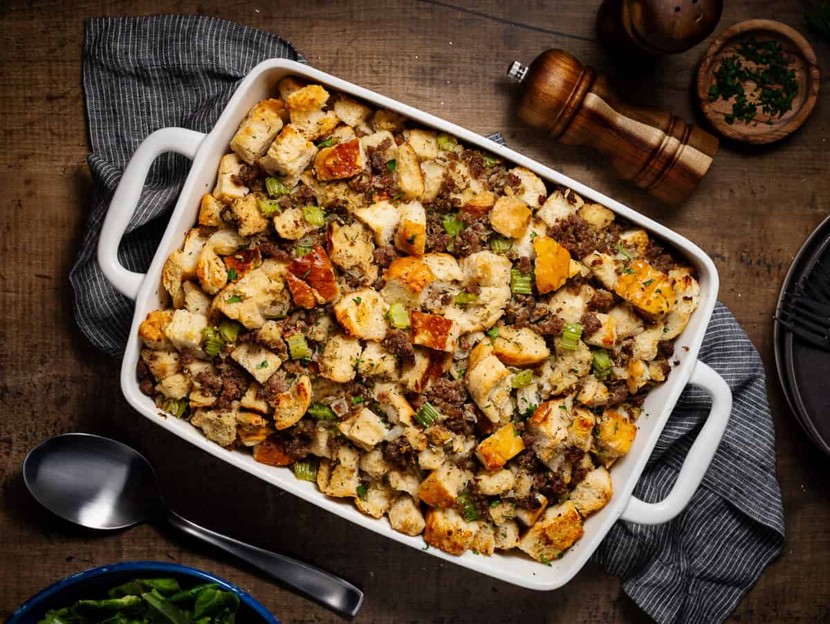 Finished Italian sausage stuffing in casserole dish on wooden background,