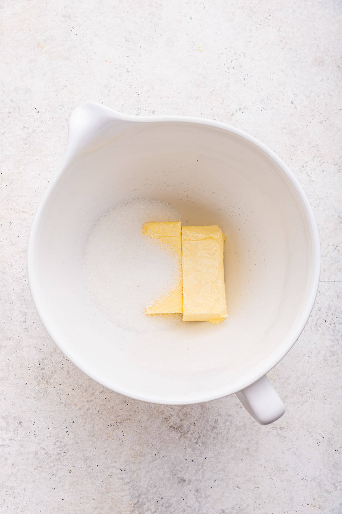 Butter and sugar in mixing bowl. 