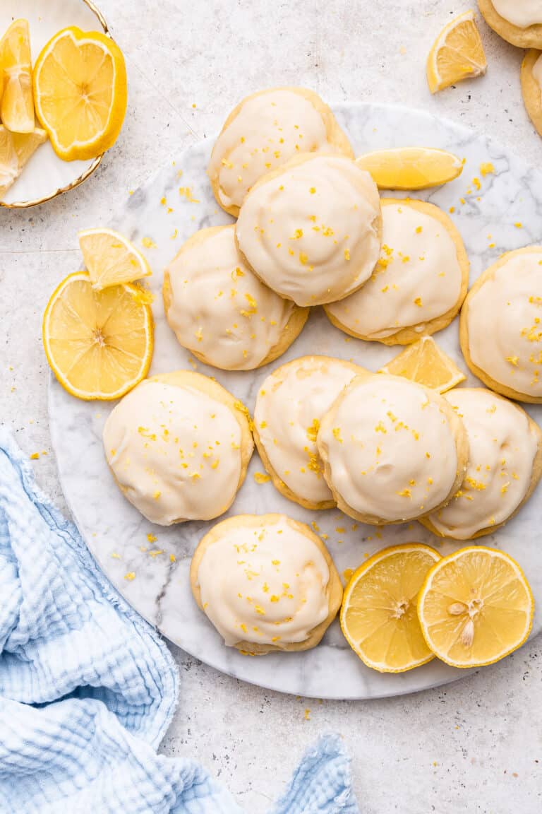 Top view of Italian lemon ricotta cookies with fresh lemon pieces.