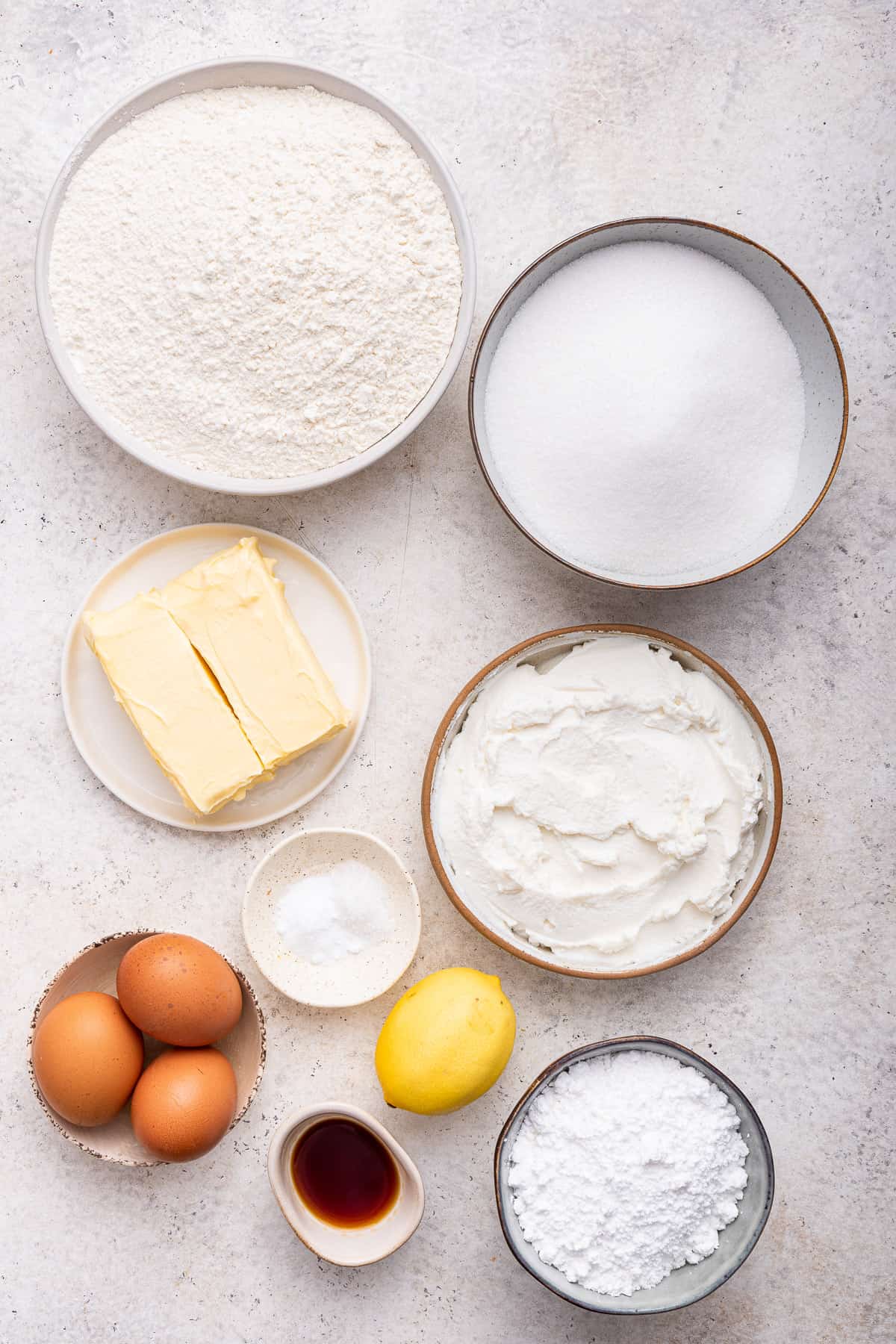 Ingredients for the lemon ricotta cookies on a grey background.
