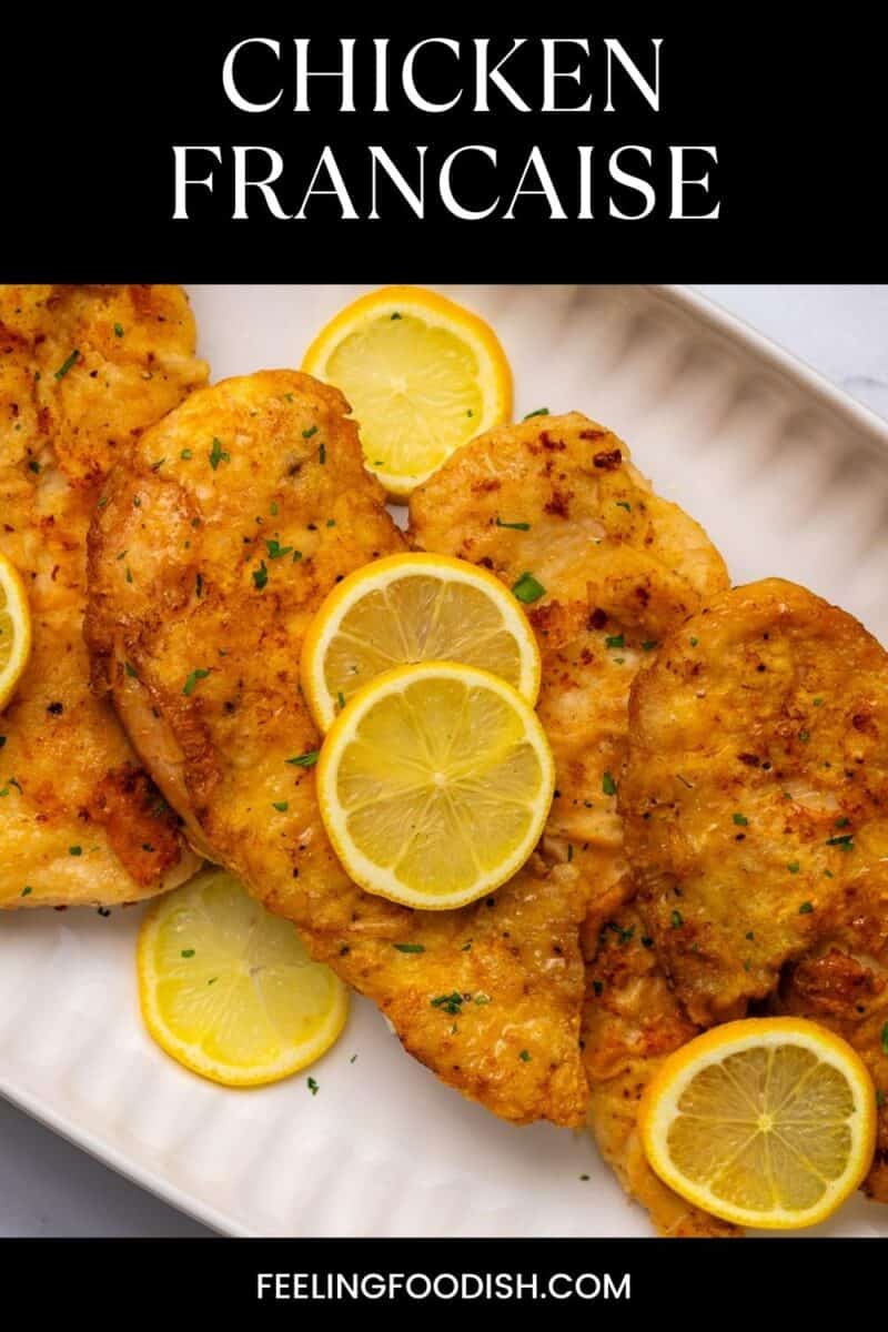 Plate of chicken francaise with lemon slices.
