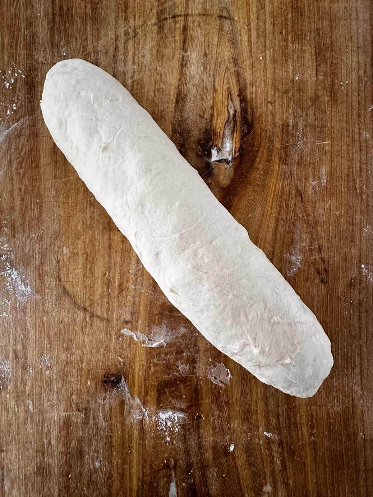Long loaf of Italian bread dough shaped