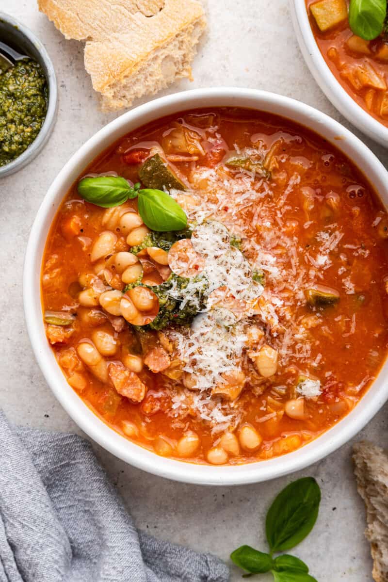 Soup topped with grated cheese in bowl.