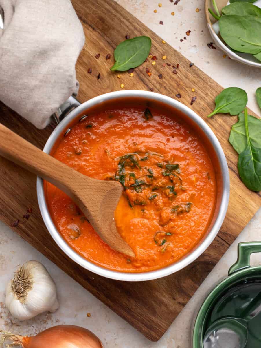 Tomato Florentine soup with wooden spoon. 