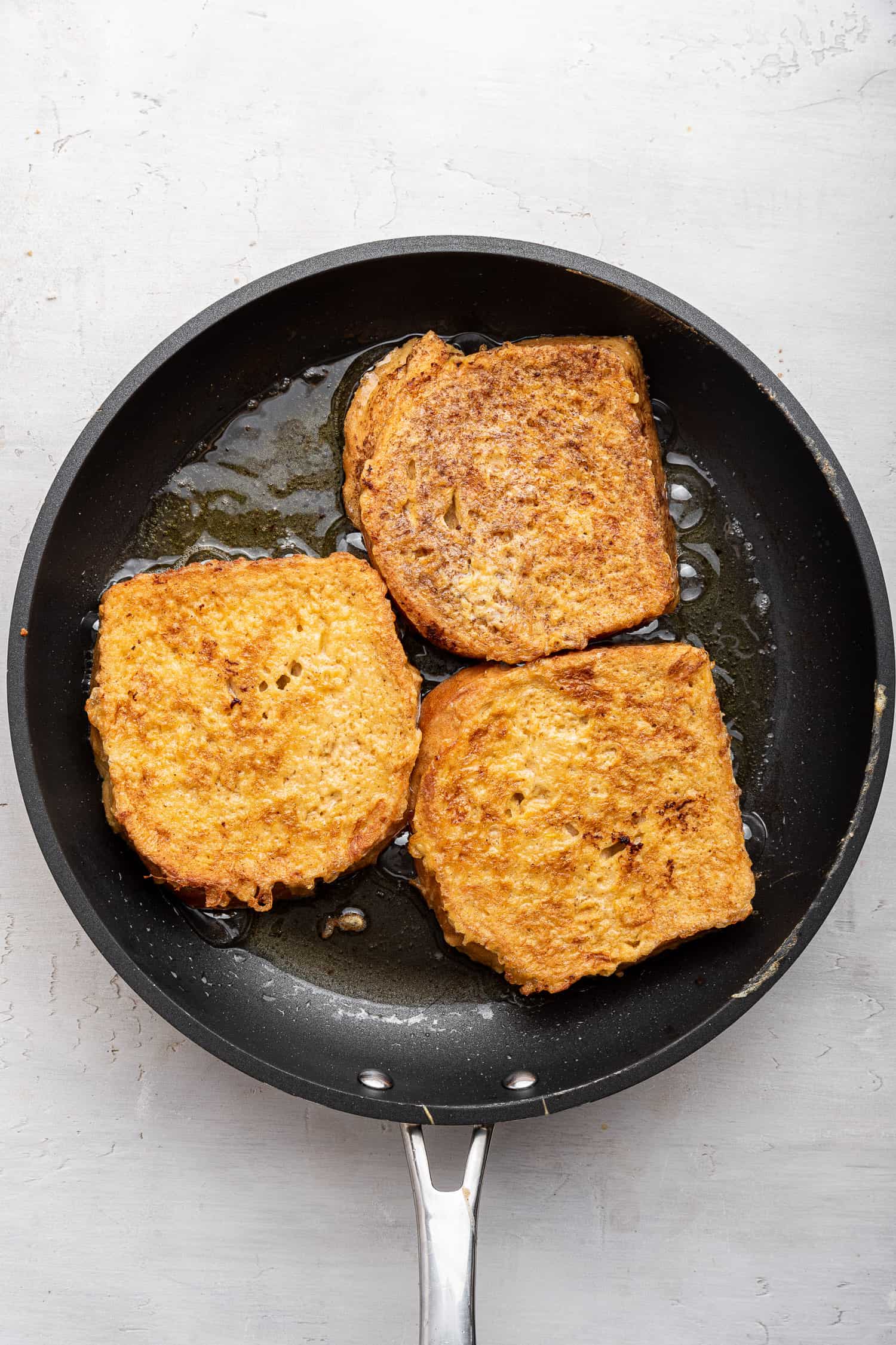 Browning the French toast in a pan. 