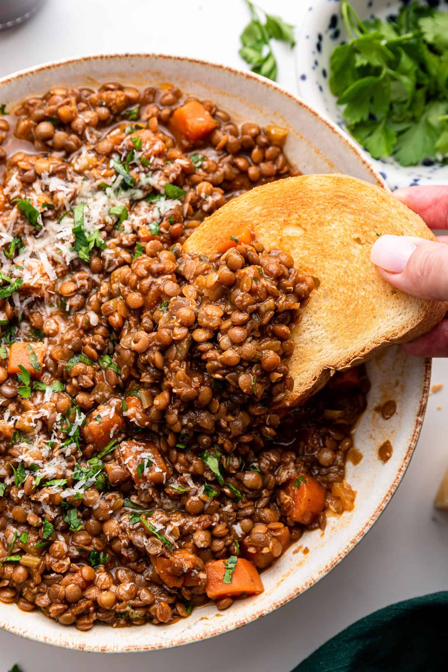 Bowl of Italian lentils with bread. 