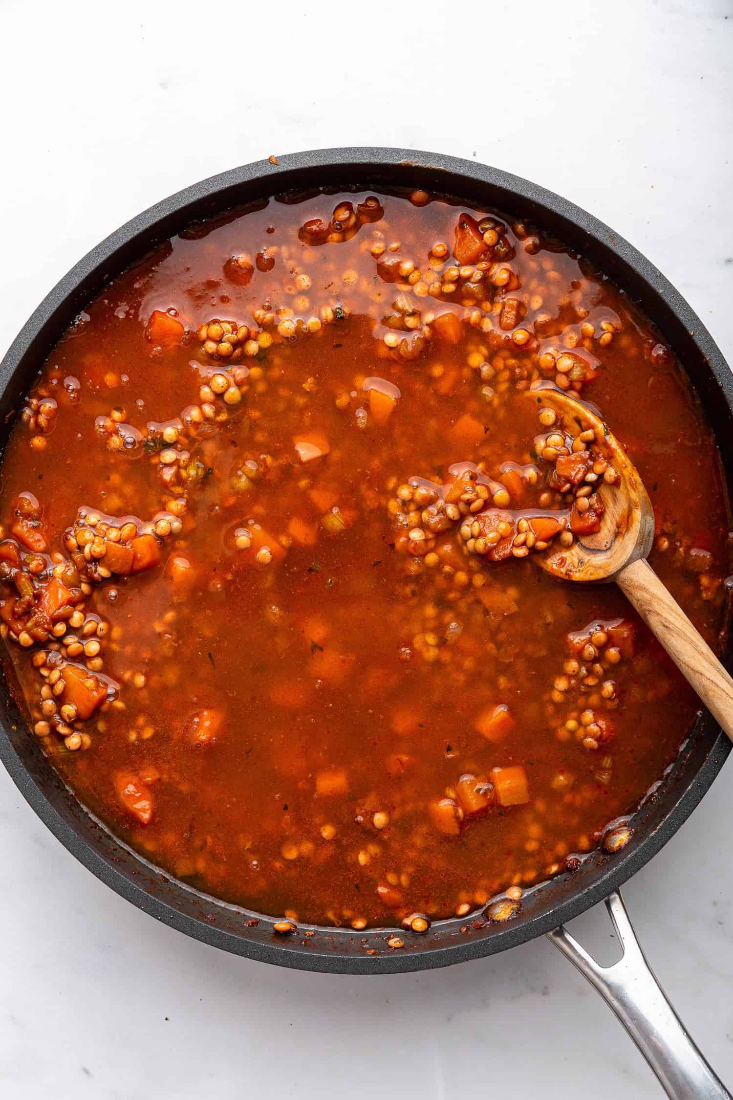 Added water to the lentil mixture in the pan. 