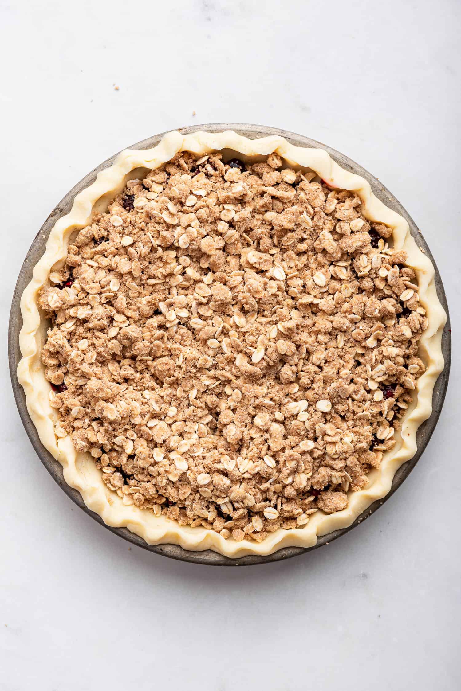 Pie filled and topped with crumble topping but unbaked.