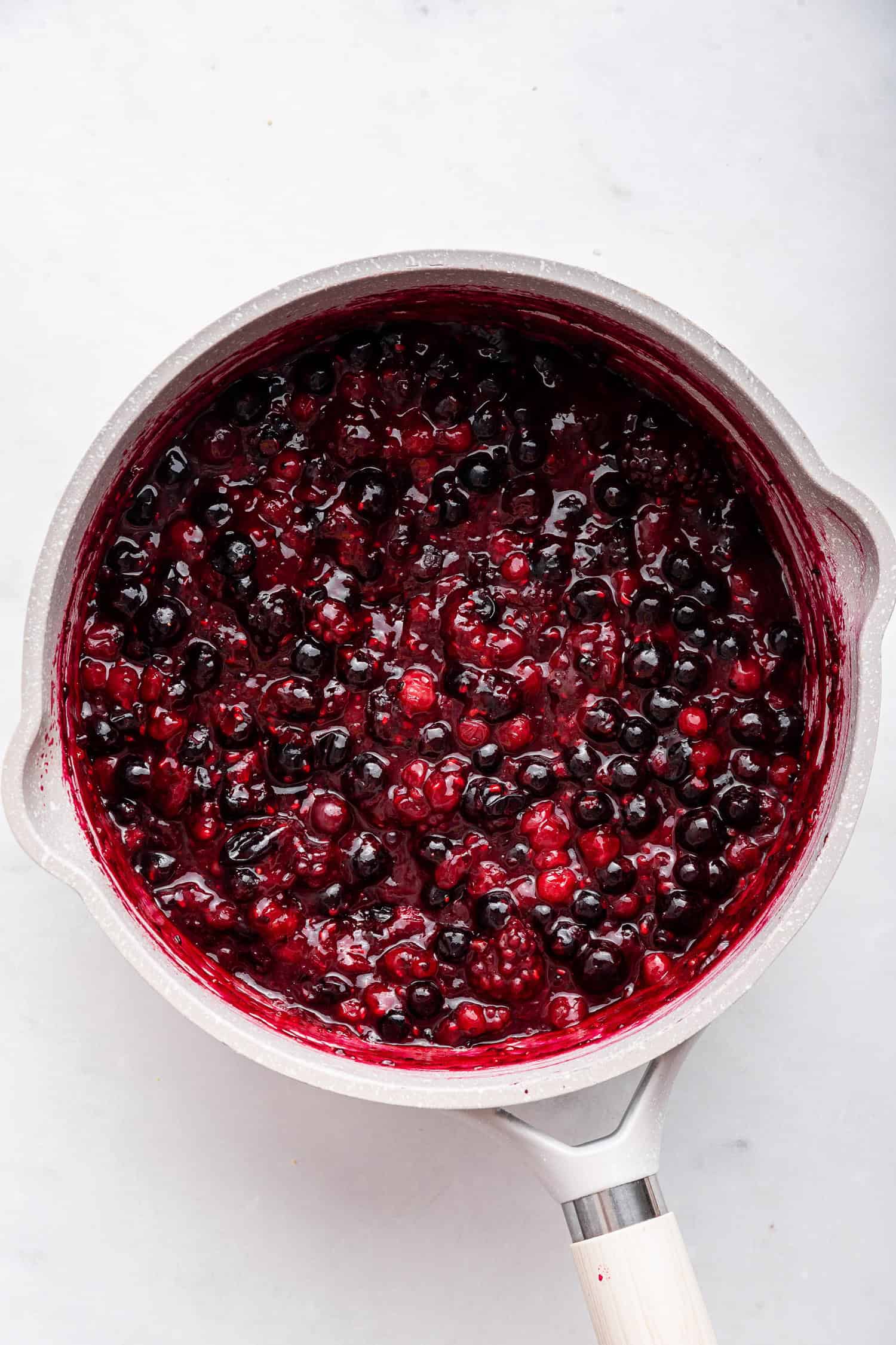 Cooked berries in sauce pan.