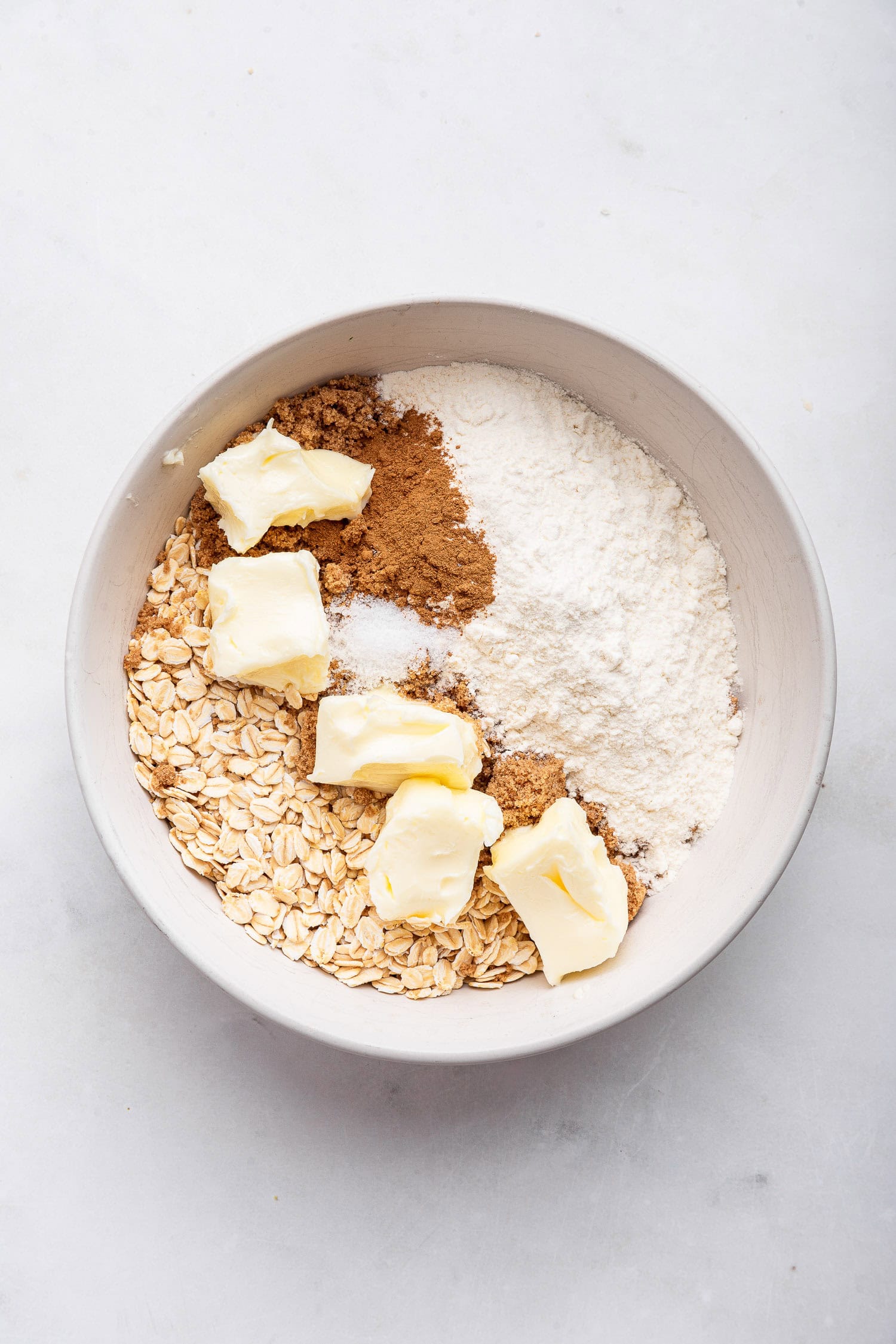 Topping ingredients before mixing in white bowl. 