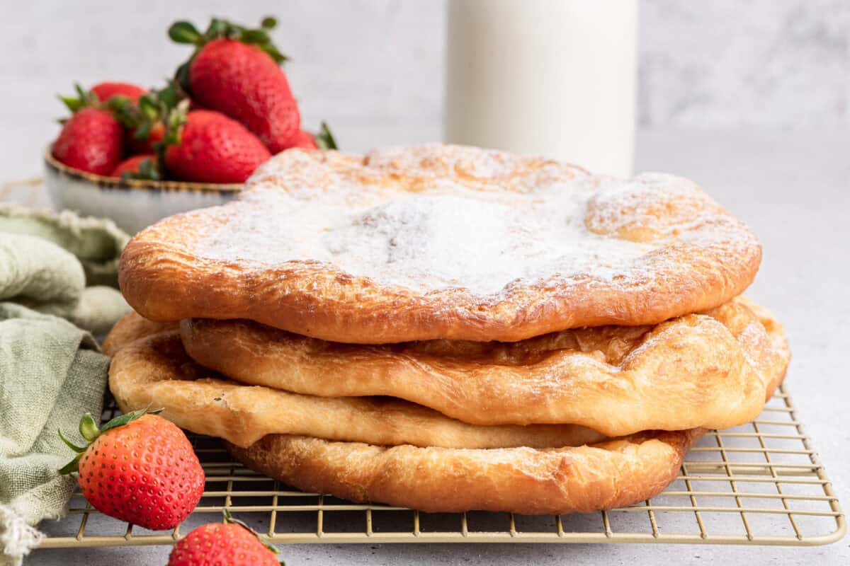 Stack of pizza fritta with powdered sugar.