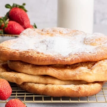 Stack of pizza fritta with powdered sugar.