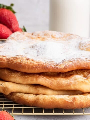 Stack of pizza fritta with powdered sugar.