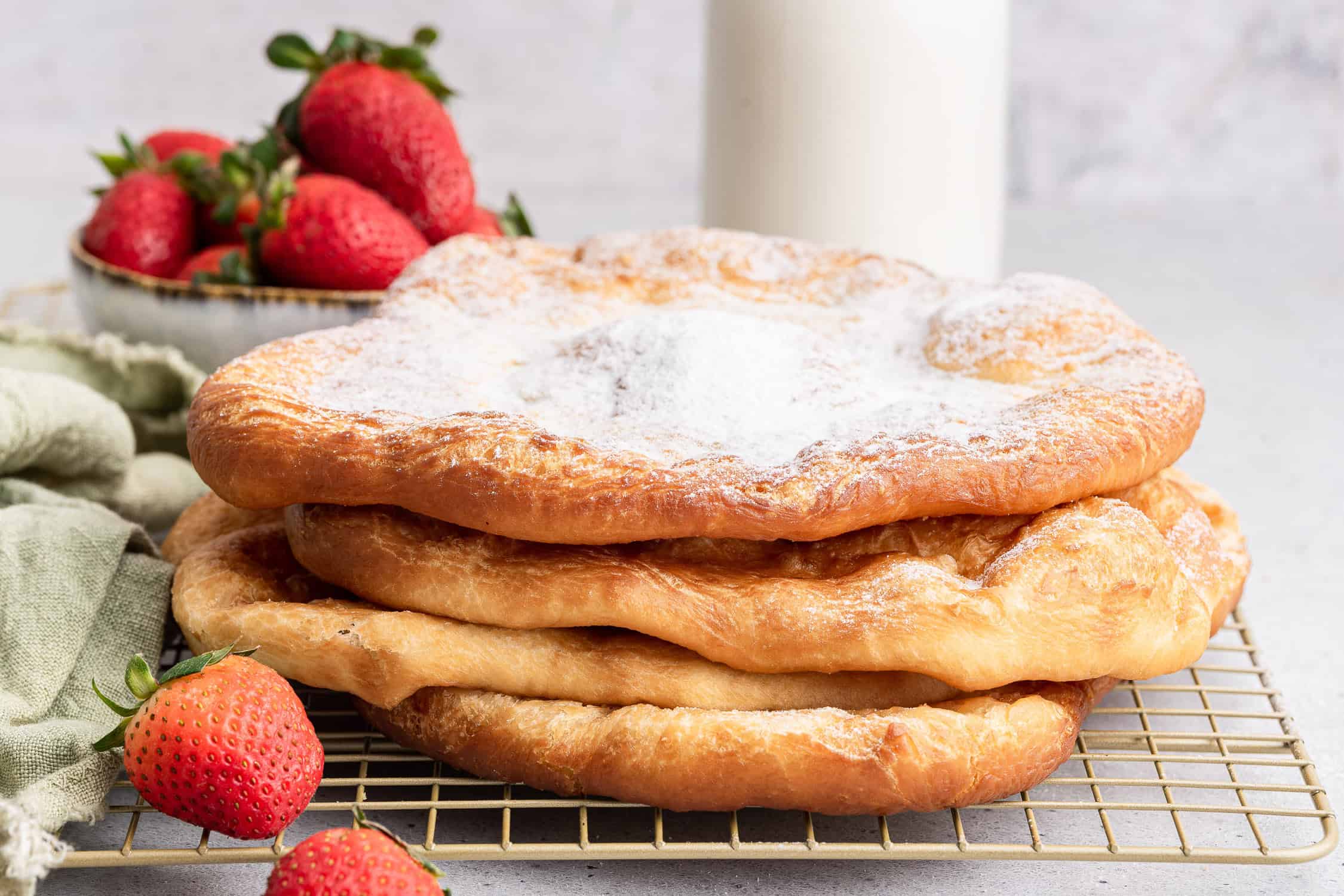 Stack of pizza fritta with powdered sugar. 