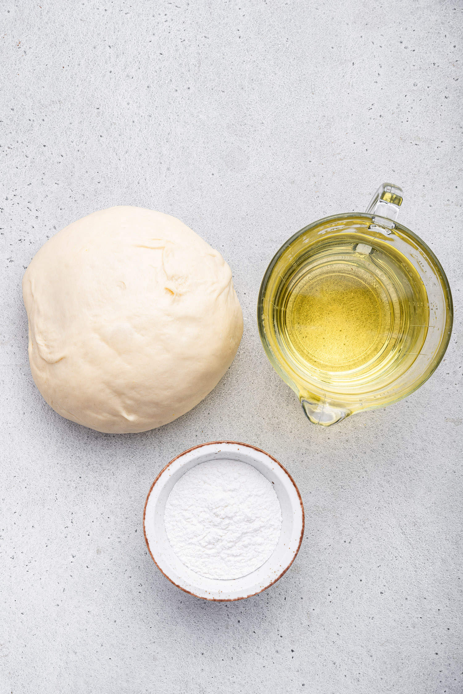 Simple ingredients for pizza fritta include pizza dough, oil for frying and powdered sugar for topping. 