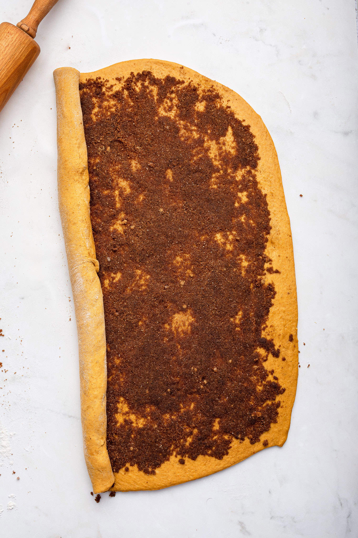 Rolling the dough with sugar mixture inside. 