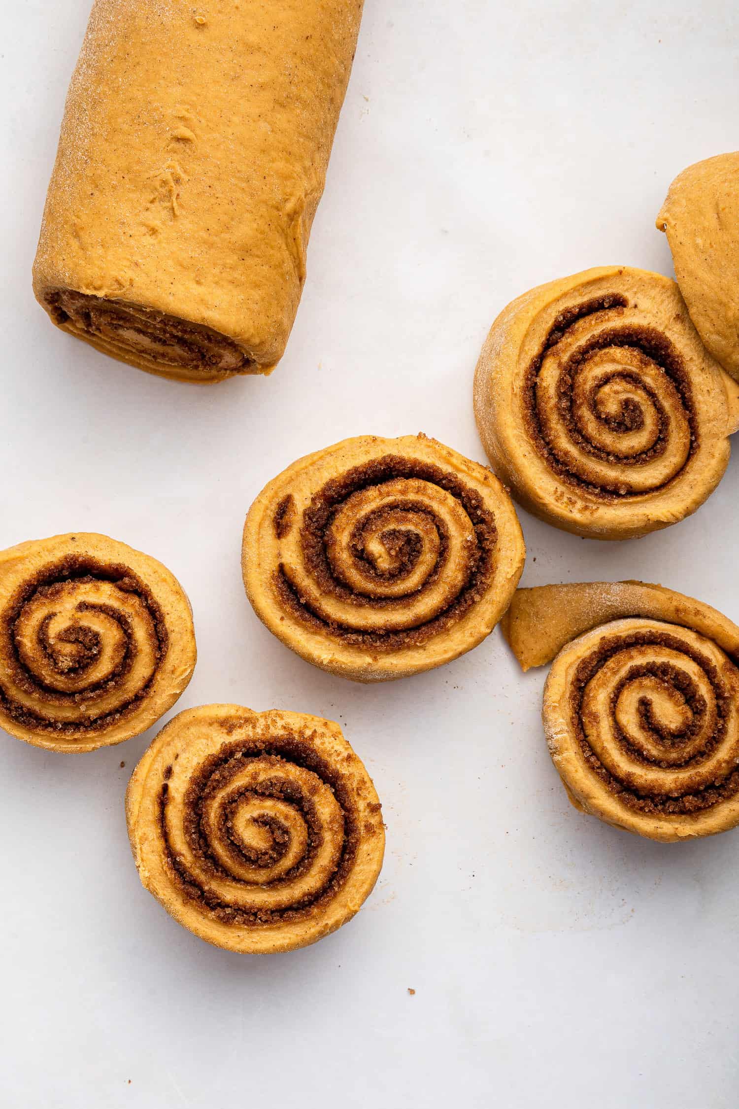 Rolls cut from long roll of dough to form buns. 