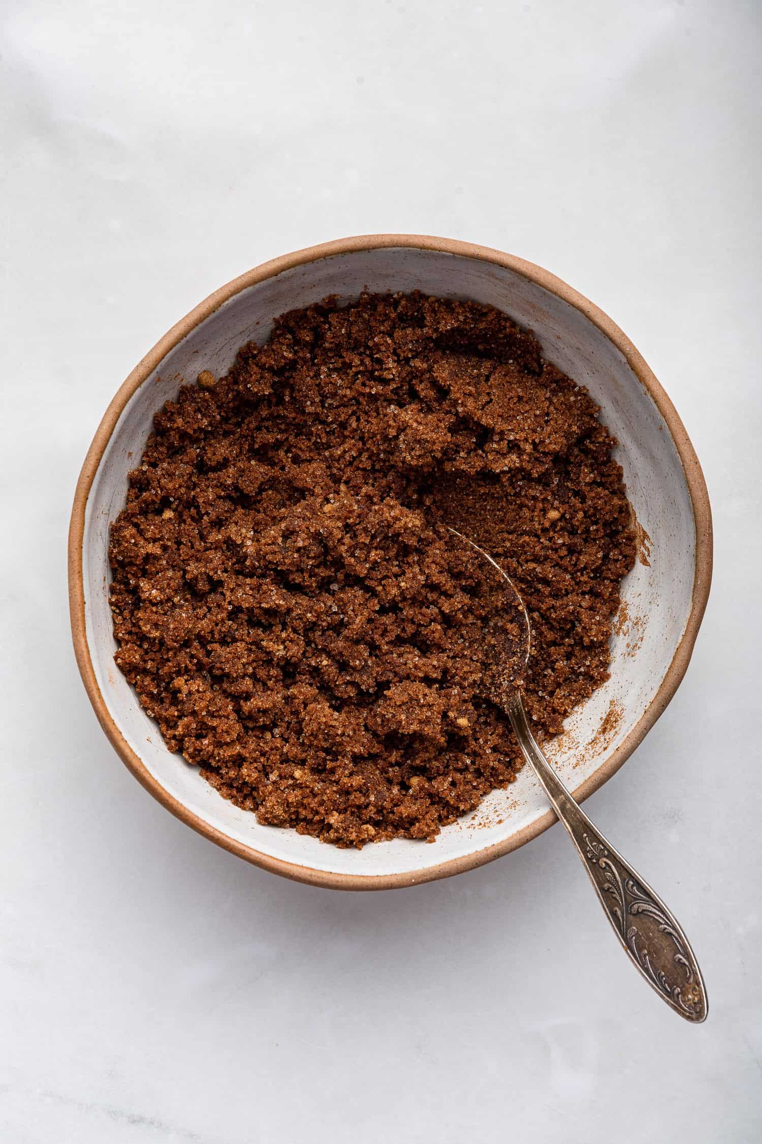 Cinnamon sugar filling all mixed in large bowl with spoon. 