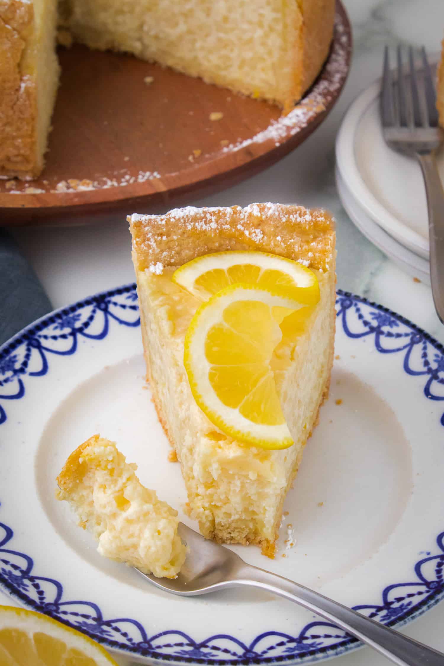 Close up slice of Italian rice pie with bite taken out on blue and white plate. 