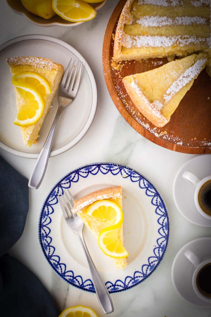 Slices of Italian rice pie on plates with forks. 