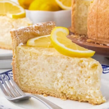 Slice of Italian rice pie on blue and white plate with fork.