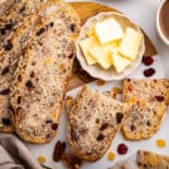 Sliced cranberry nut bread with butter.