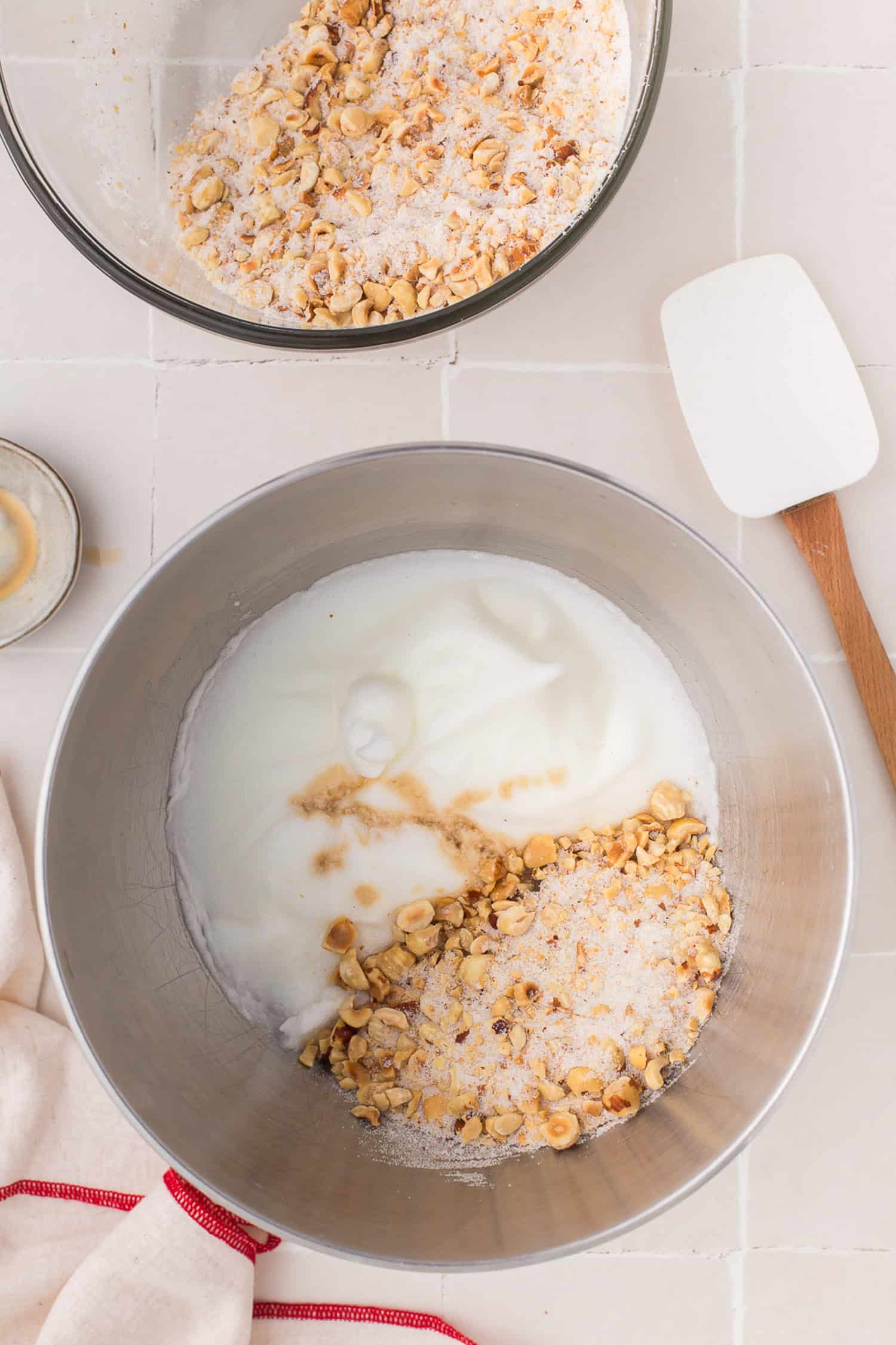 Folding egg white with sugar nut mixture. 