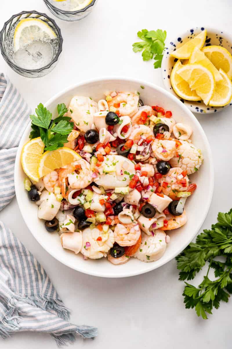 Italian seafood salad in white bowl.