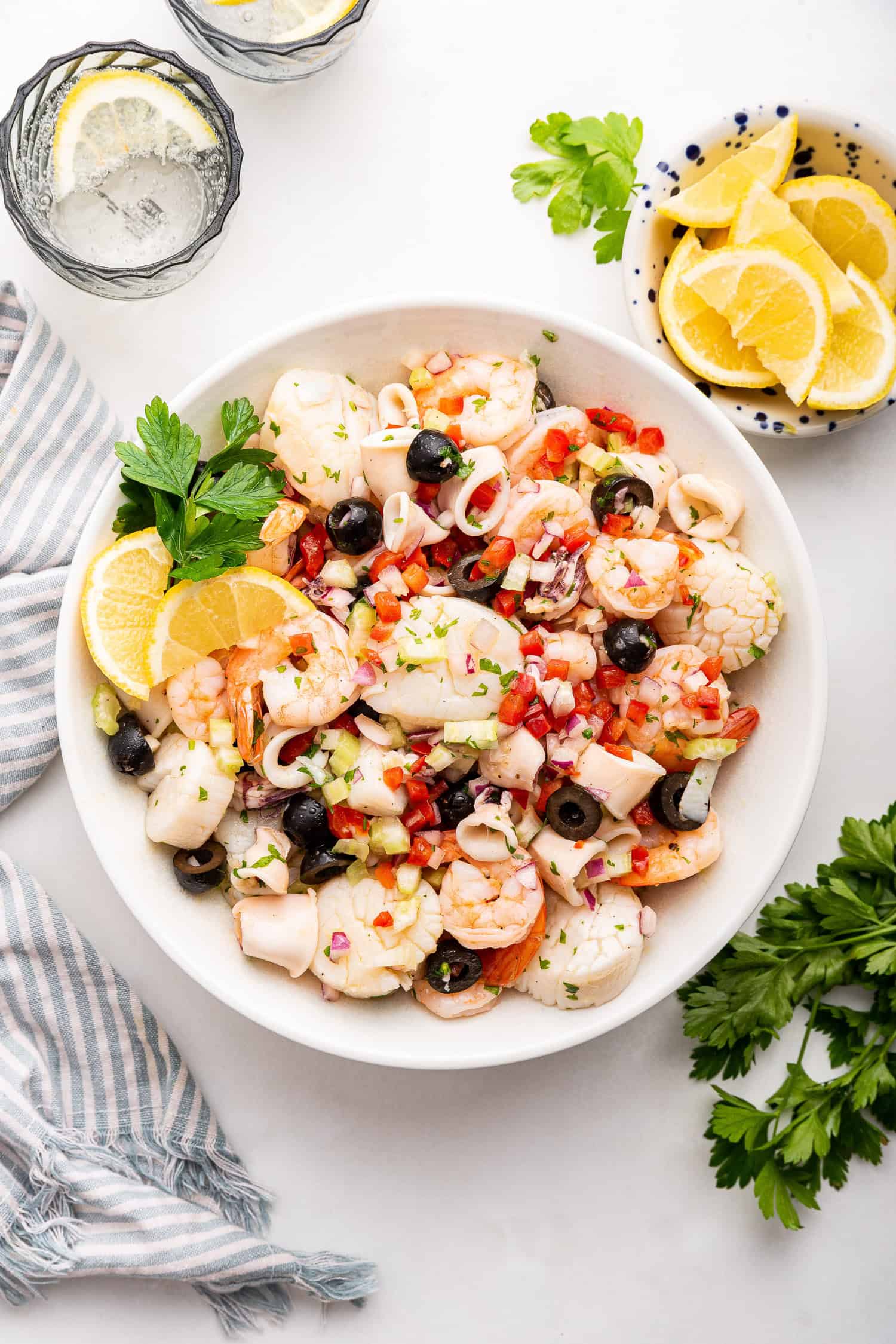 Italian seafood salad in white bowl.