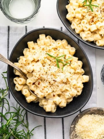 Velvety pasta with chickpeas in bowl with spoon.