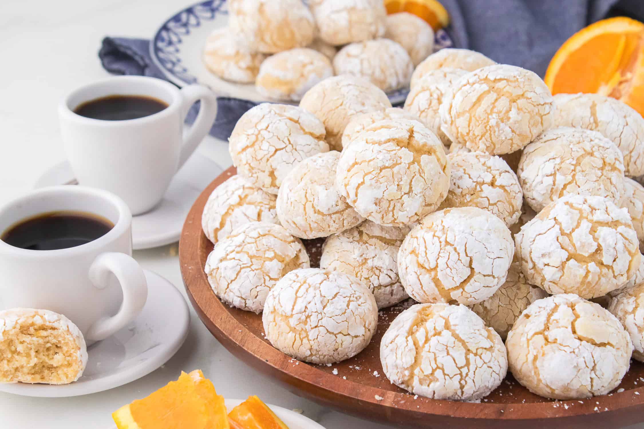 Dish of orange cookies with coffee.