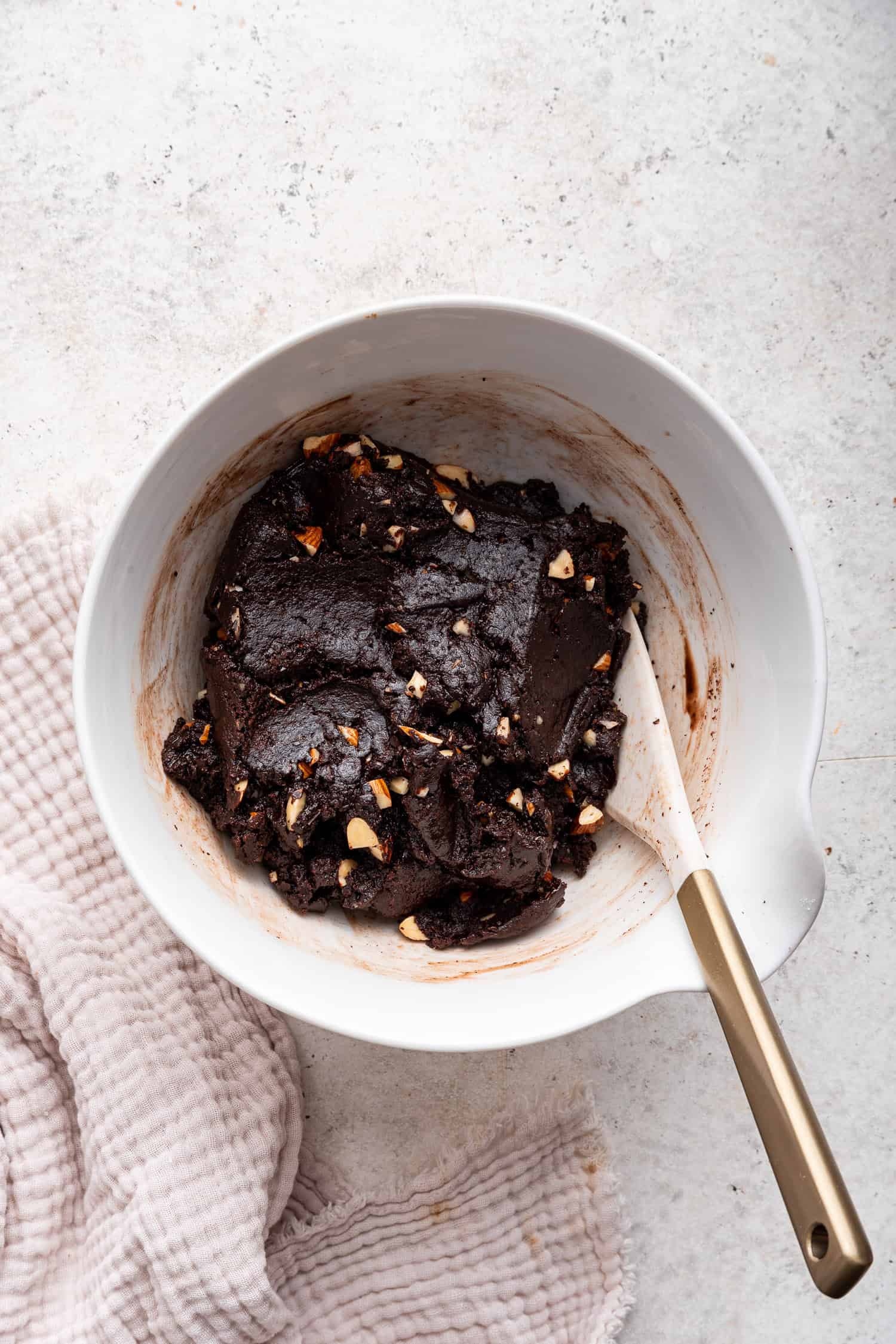 Mixed cookie dough in white bowl. 